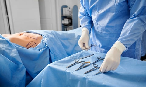 Surgeon preparing dissector surgical instruments