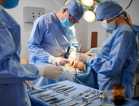 Surgical team using dissector instruments in operating room