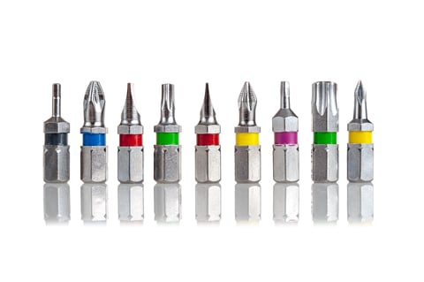 Attachments for a replaceable screwdriver, unscrewing heads, isolated on a white background, close-up