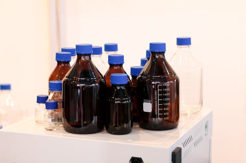 Empty glass reagent bottles in chemical laboratory. Selective focus.