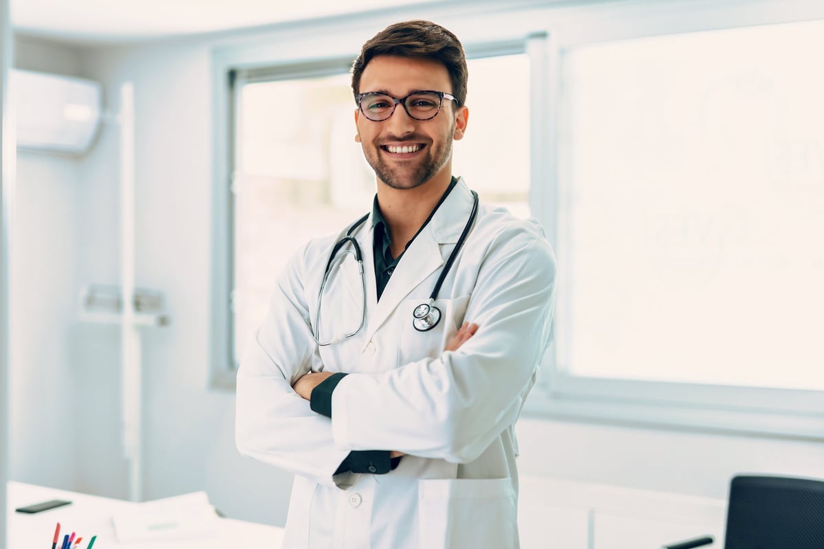 Portrait of handsome male doctor with stethoscope over neck working