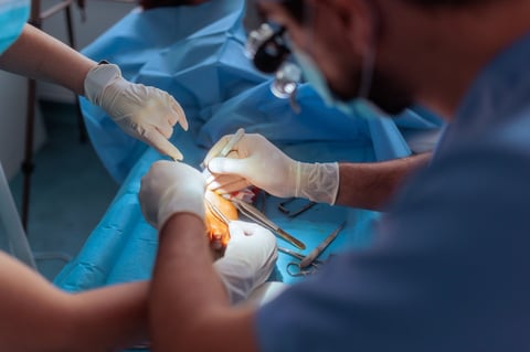 Surgeon performing arm surgery in the operating room