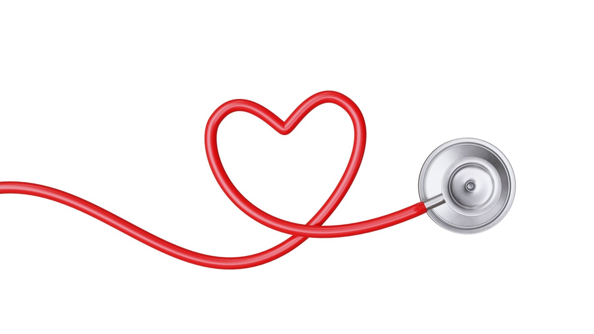 Medical stethoscope and red heart isolated on white