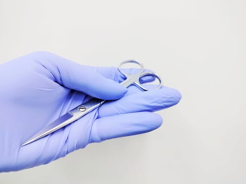 Nurse holding sterile surgical scissors