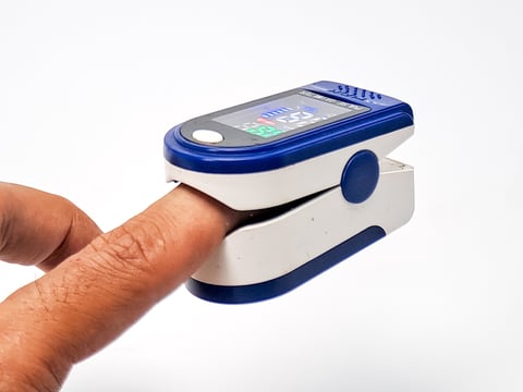 A blue and white digital pulse oximeter, used for quick health checks