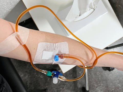 Top view of a hand with a cannula for medical infusion