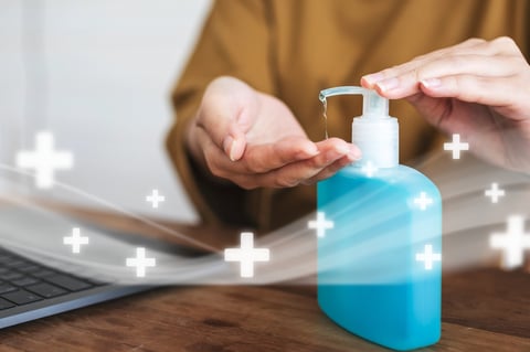 Woman cleaning hands with a hand sanitizer gel