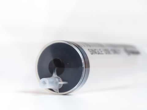 Closeup of syringe on gray background
