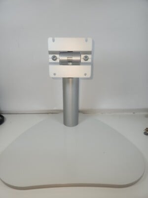 White monitor stand with gray metal pole and white base mounted on a flat surface