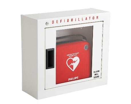White wall-mounted defibrillator cabinet with clear window displaying red Philips automated external defibrillator (AED) unit inside