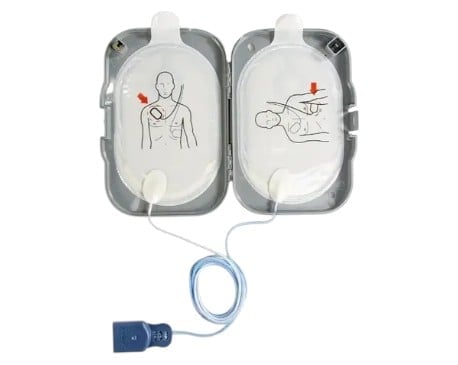 Automated external defibrillator pads showing chest placement diagrams for adult and child use with connecting cable