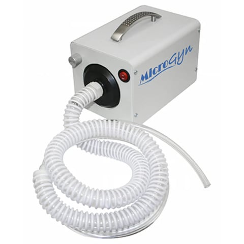 MicroSun white portable dental suction machine with clear flexible tubing coiled on white background