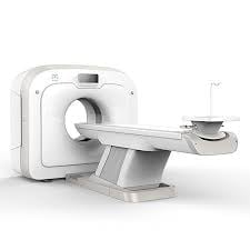 White CT scan medical imaging machine with sliding patient table on white background
