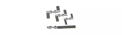 Collection of dark gray metal hardware pieces and fasteners arranged on white background