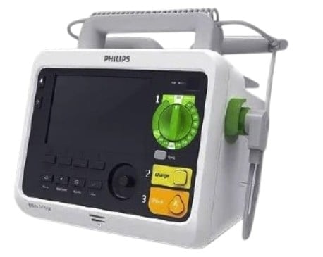 Philips medical defibrillator device with white and gray casing, featuring a touchscreen display, control buttons, and green and yellow interface elements