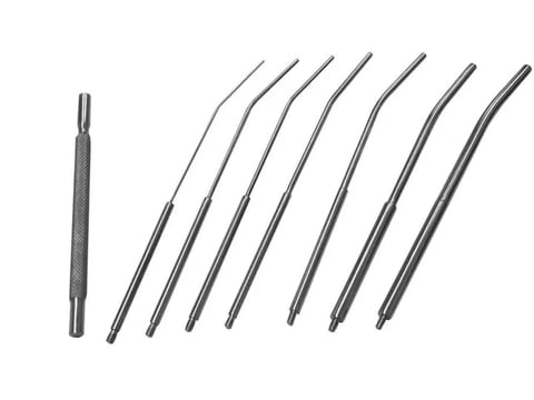 Set of precision tools including a punch tool on the left and seven curved dental picks or probes arranged diagonally