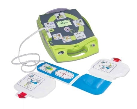 Automated external defibrillator (AED) with lime green case and white electrode pads with blue backing displayed on white background