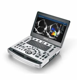 Portable ultrasound machine with screen displaying cardiac imaging and control panel with multiple dials and buttons