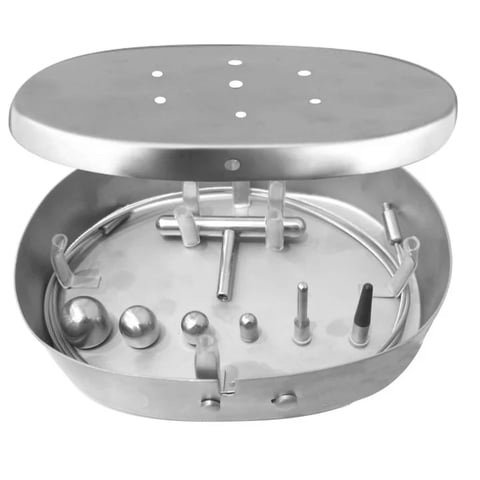 Stainless steel dental handpiece sterilization case containing various dental tools and burrs