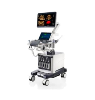 Medical ultrasound machine on wheeled cart with monitor displaying images and control panel