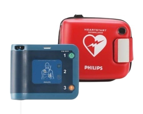 Philips HeartStart defibrillator device with blue unit showing chest diagram and red carrying case