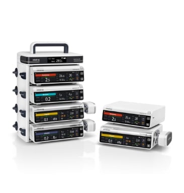 Stack of medical infusion pumps with digital displays, showing stacked units on left and separate units on right