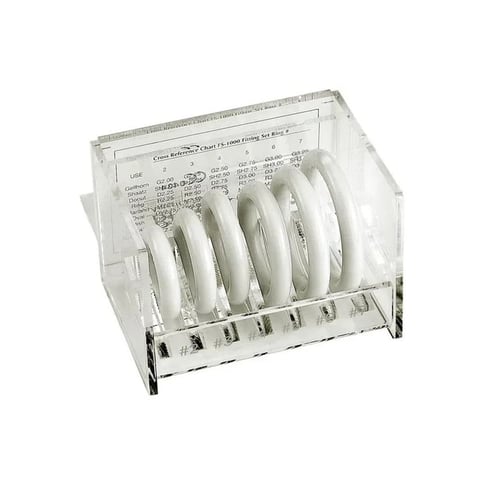 Transparent dish rack caddy holding white plates in vertical slots with instruction manual displayed at top