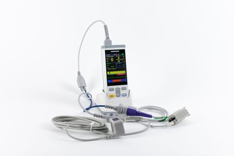 Portable pulse oximeter with digital display, probe cable, and carrying accessories on white background