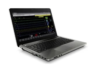 Silver laptop displaying waveform editing software on screen with keyboard and ports visible