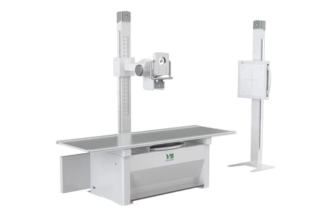 Medical X-ray equipment showing white radiography system with ceiling-mounted tube arm and separate wall-mounted control panel