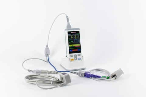 Medical pulse oximeter device with attached cables and sensors on white background