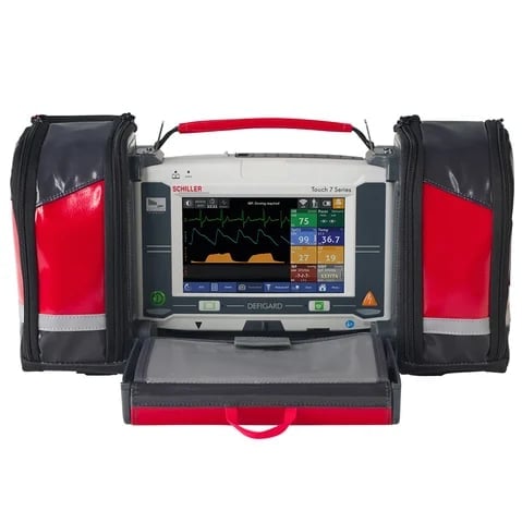 Portable medical defibrillator device with digital display and side-mounted carrying cases in red and black