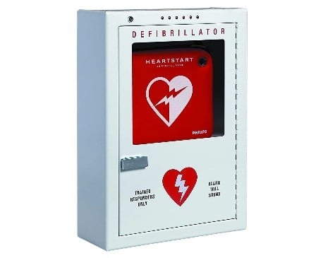 White wall-mounted Philips HeartStart automated external defibrillator (AED) with red heart symbol and emergency instructions
