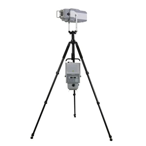 Survey laser level equipment mounted on black tripod stand with gray digital device and sensor on top