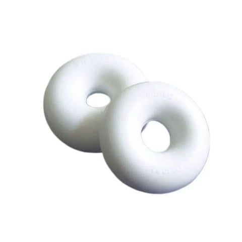 Two white ceramic donuts with holes arranged side by side