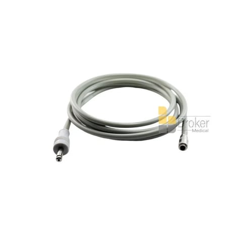 Coiled medical cable with gray tubing and metal connectors on both ends against white background