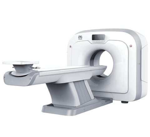 White CT scan machine with gantry and patient table against white background