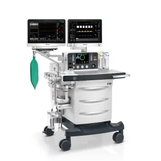 Medical anesthesia machine with monitors, controls, and green gas canister mounted on mobile cart